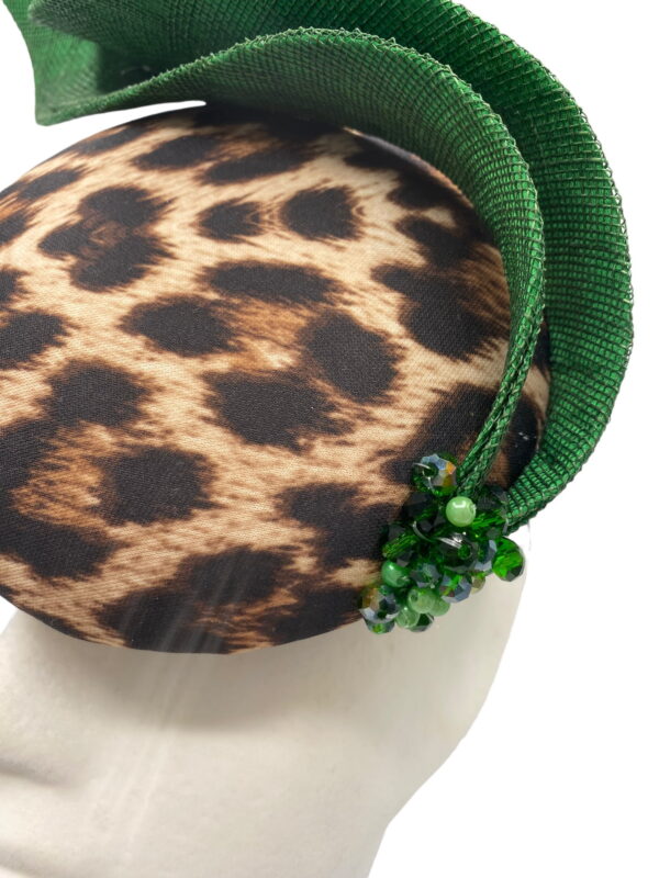 Leopard print base headpiece, finished with a green swirl detail to the top.